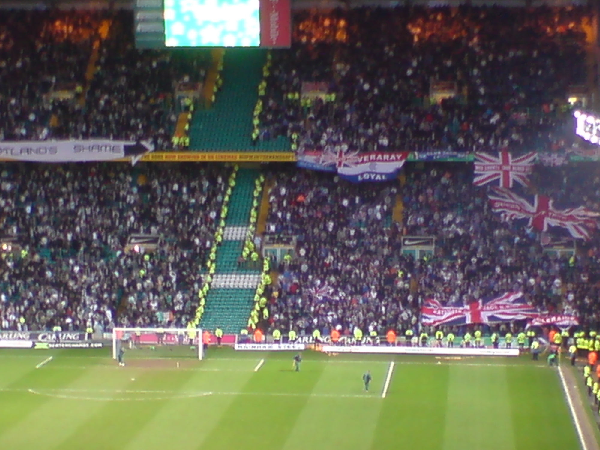Celtic and Rangers supporters displaying their colours during an Old Firm derby in Glasgow
