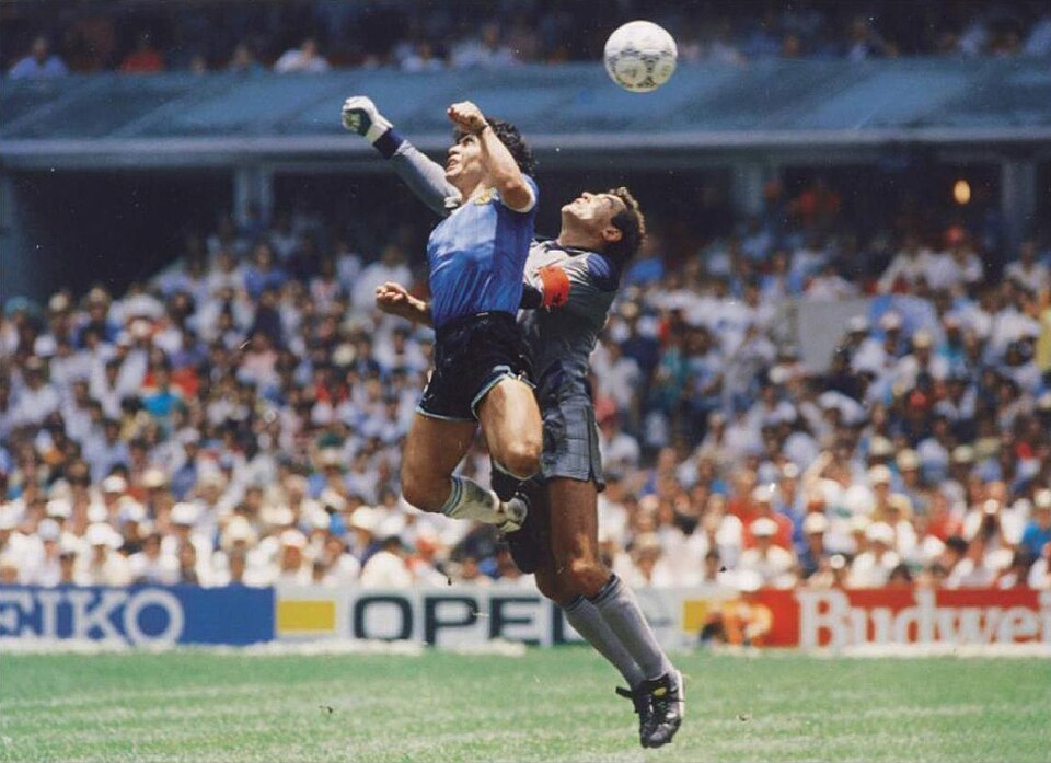 Diego Maradona scoring the Hand of God against England goalkeeper Peter Shilton at the 1986 World Cup